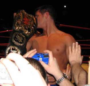 Cody kissing his tag team title
